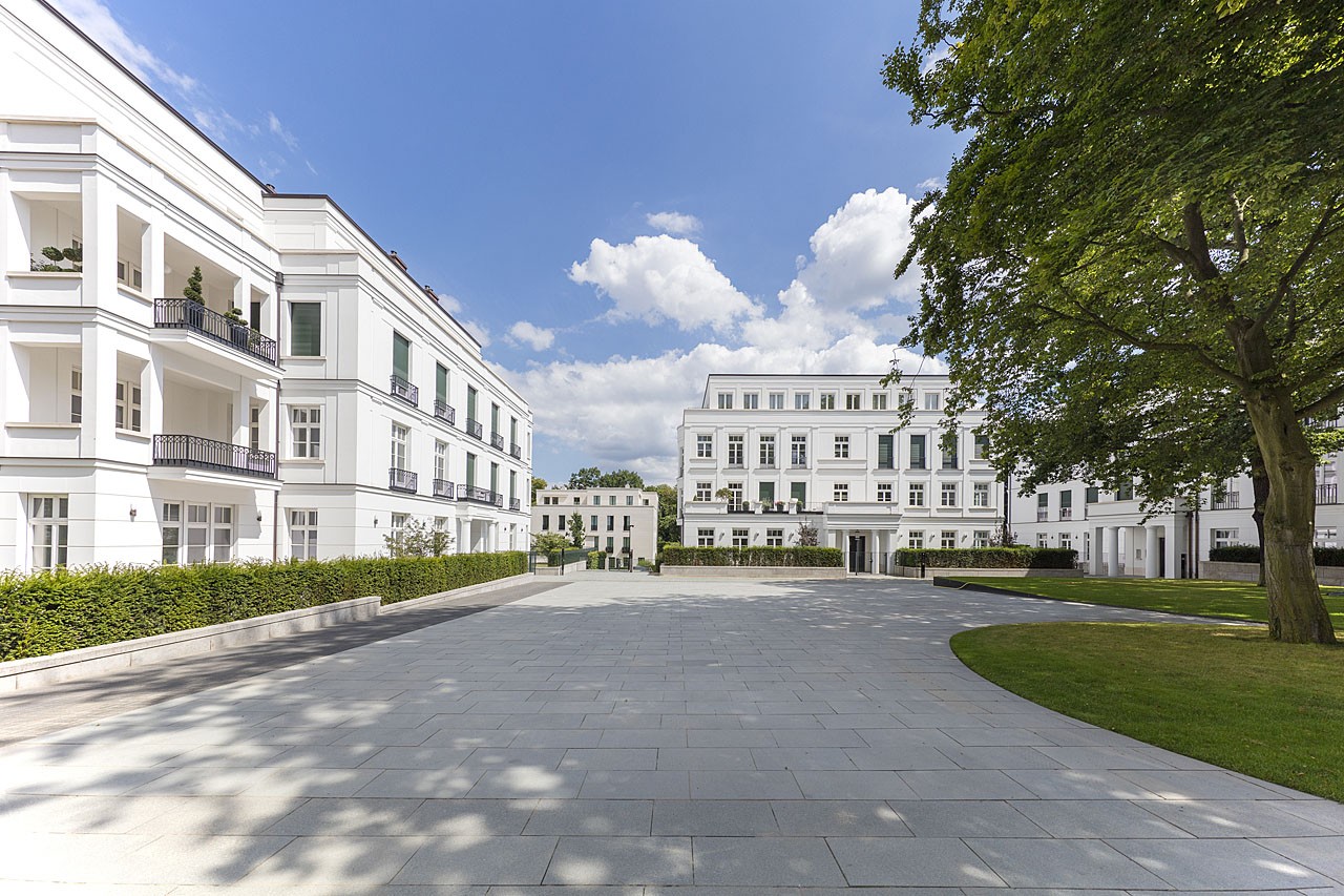 Sophienterrassen neighbourhood square with light paving between white residential buildings and lawns